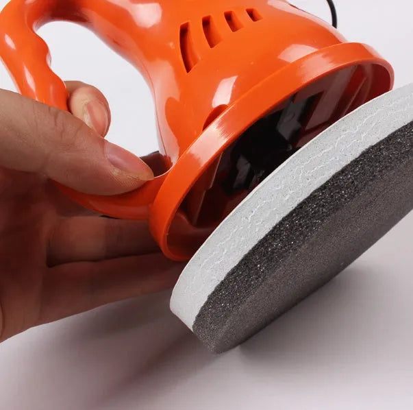 Black 12V car waxing glaze polishing machine with orange switch handle on white background