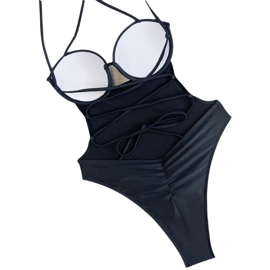 A black one-piece swimsuit for women made from spandex, laid flat.