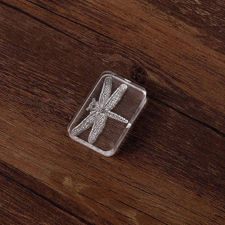 Transparent acrylic hand account seal with clear silicone components on bottom card packaging