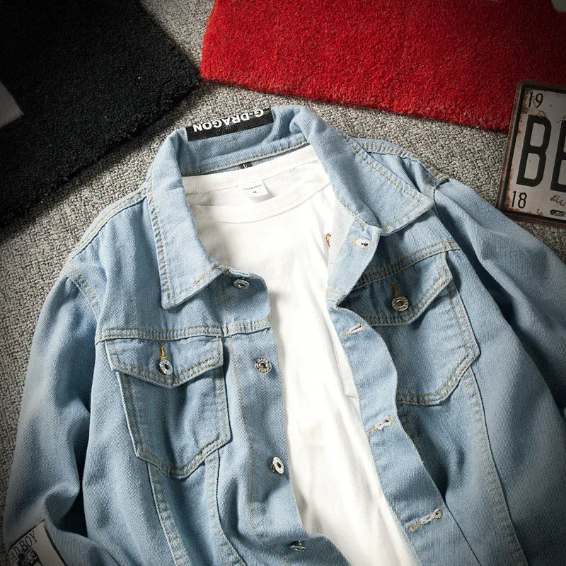 Men's blue denim jacket with lapel collar, single-breasted front, and side seam pockets on a model