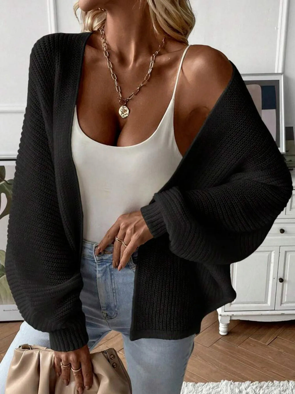 Women's loose-fit batwing sleeve cardigan in solid colour, made from thin polyester fabric.
