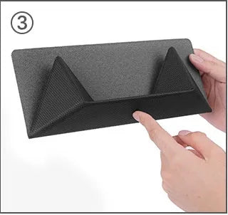 Blue foldable aluminium laptop cooling bracket open on a desk next to a laptop.