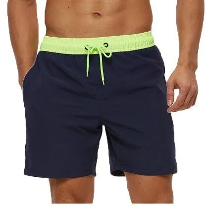 Men's blue drawstring fitness shorts with a zippered side pocket and stitching detail on the waistband.