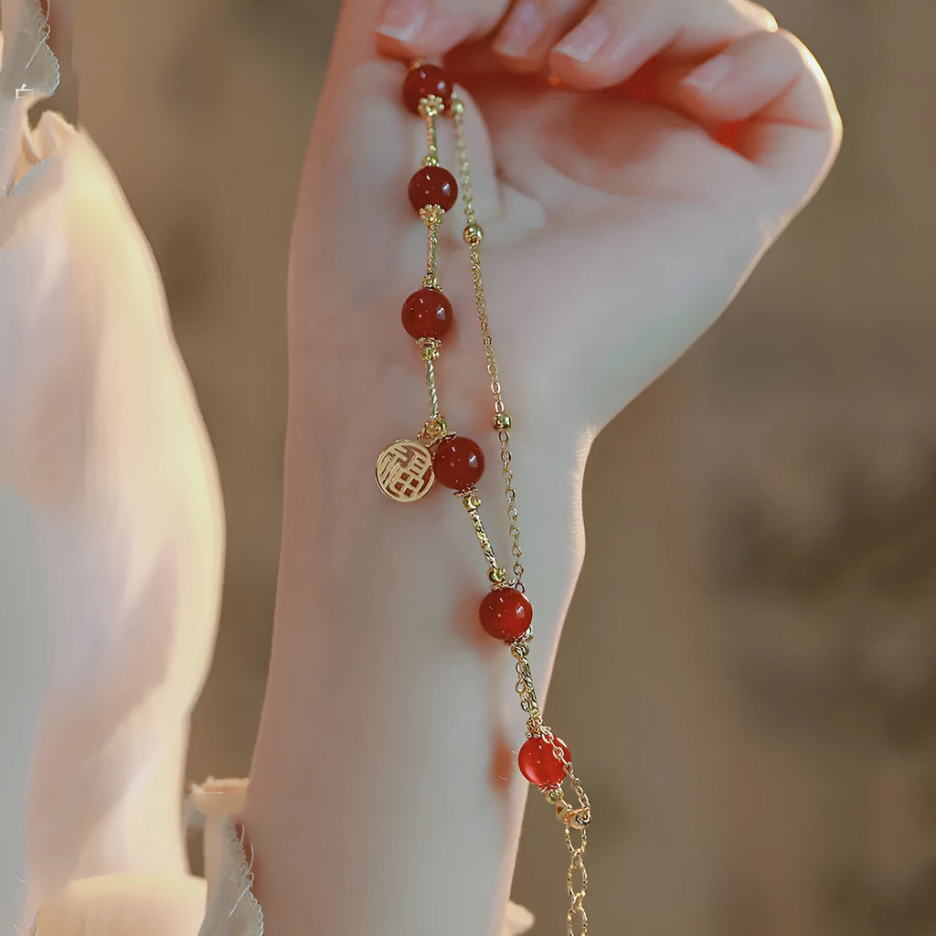 Red agate and alloy double-layer women's bracelet with a Red Horse blessing card charm on a white background.