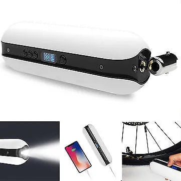 White portable electric tyre inflator with accessories on a non-slip mat, showing compact size and USB cable