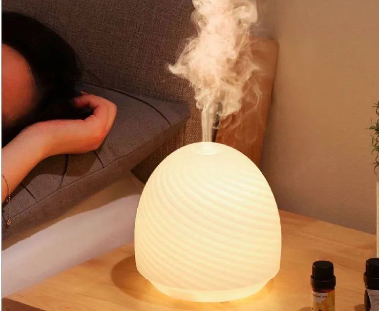 Asakusa threaded glass aroma diffuser in frosted white on a table with a single fog outlet
