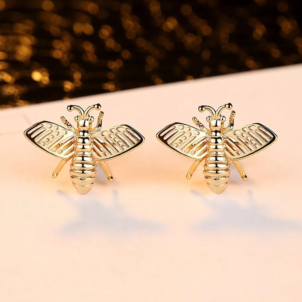 Three styles of Korean inlaid crystal rhinestone bee and flower stud earrings on a white background