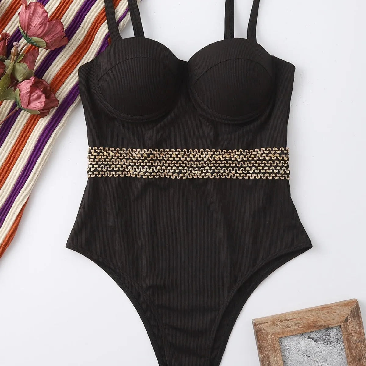 Black one-piece swimsuit for women with a matching hard storage bag featuring an adjustable shoulder strap.