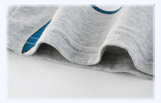 Grey cotton children's T-shirt laid flat, showing plain front and detailed size label.