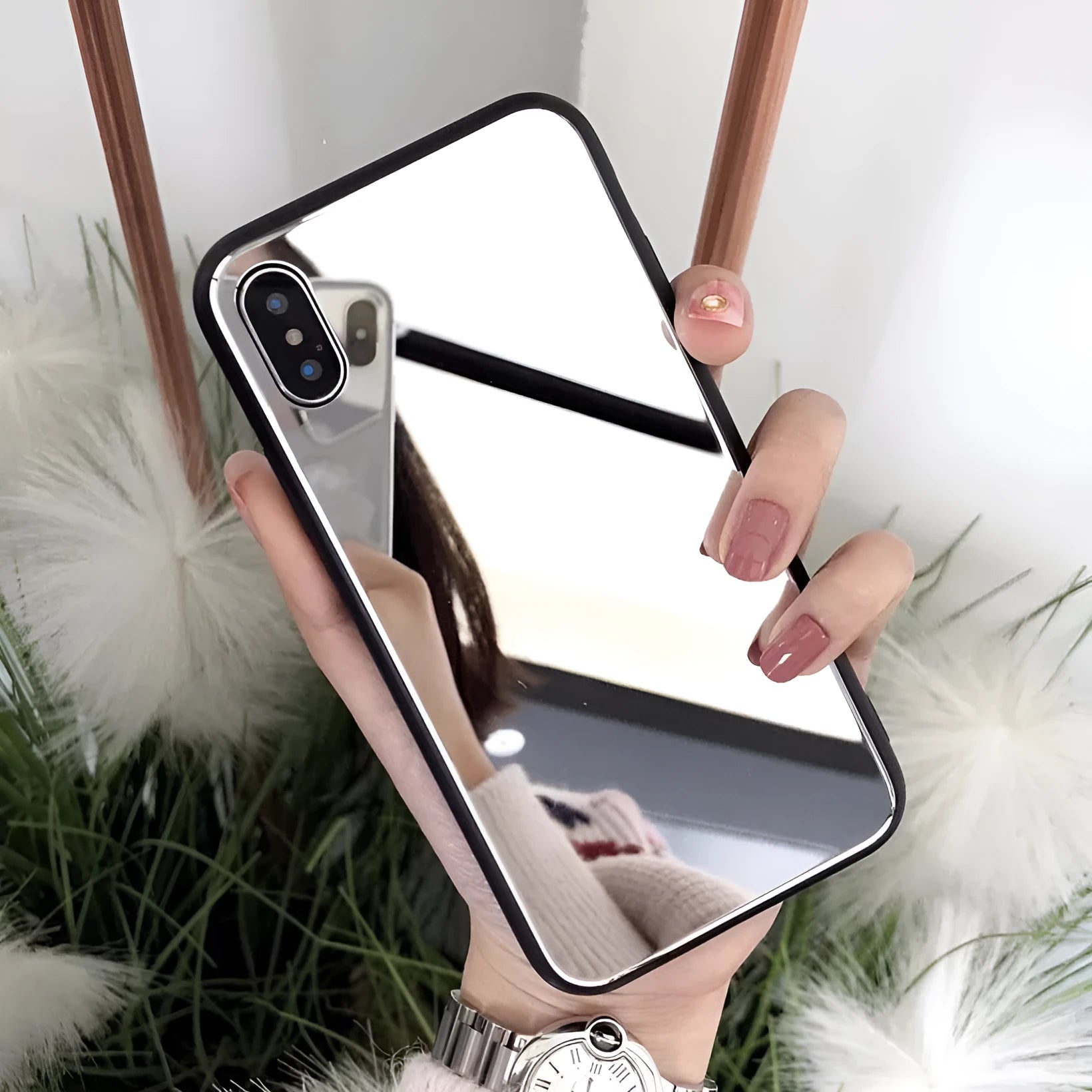 Black iPhone mirror phone case with reflective back cover for iPhone X and other models.