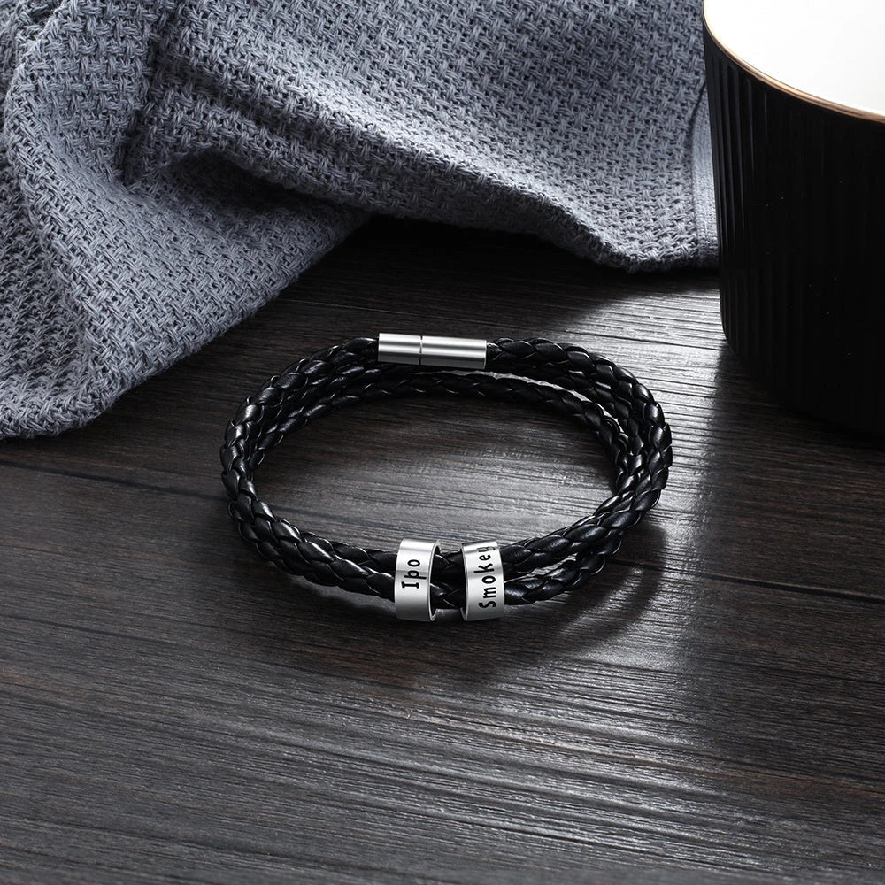 Personalized braided leather bracelet with engraved charm for men, available in black, brown, and navy colors