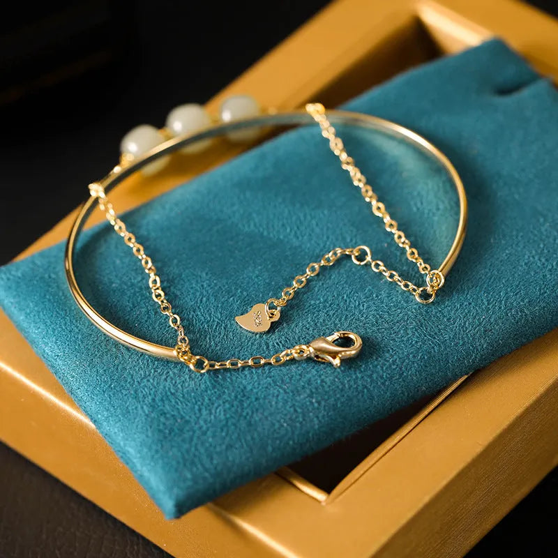 Women's jade bracelet with gold inlay detailing showing single bead version