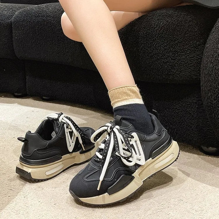 Women's black retro platform sports shoes with round toe and lace-up front on white background