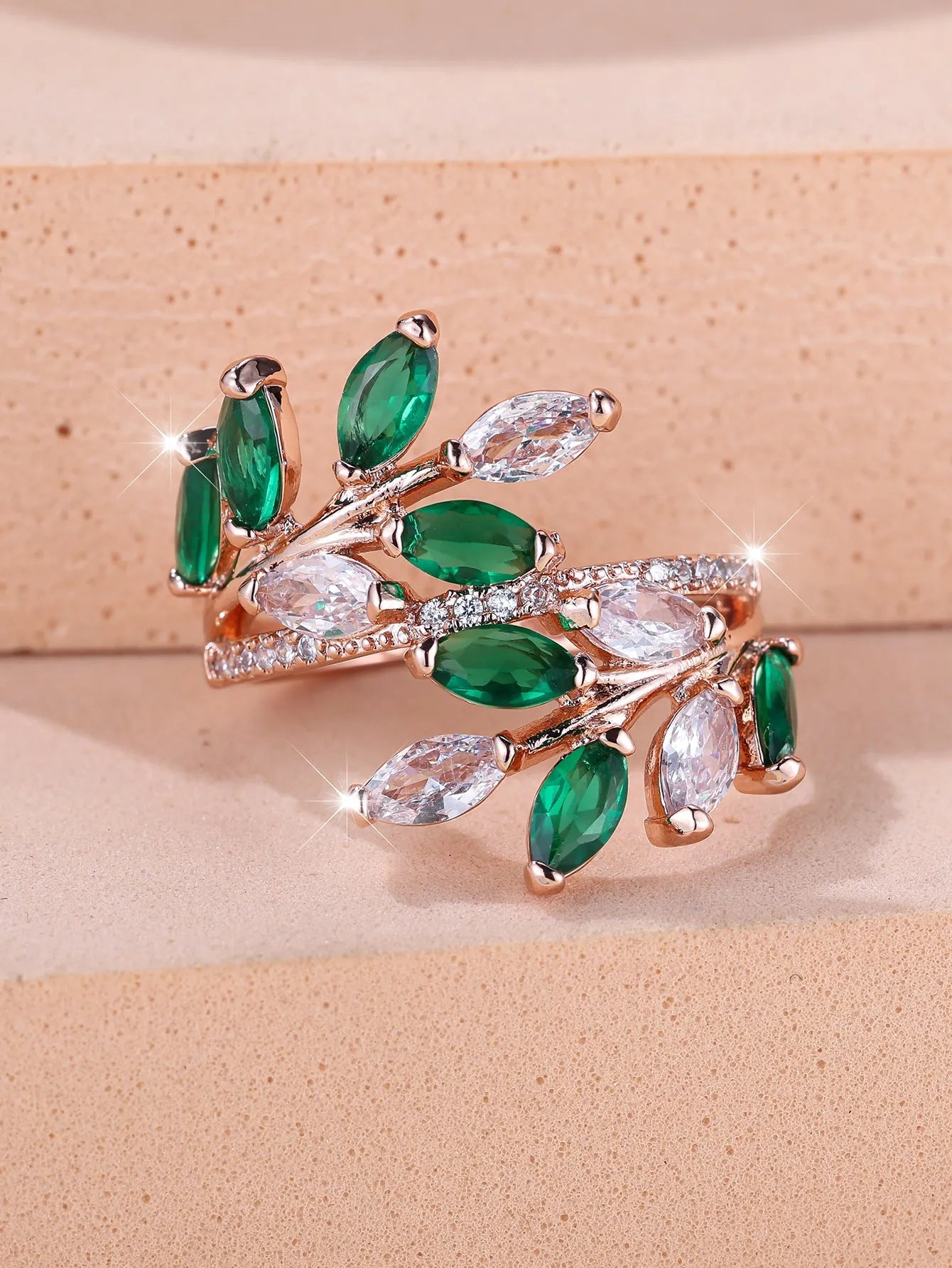 Adjustable copper leaf ring with a zircon stone in a choice of rose gold or platinum finishes.