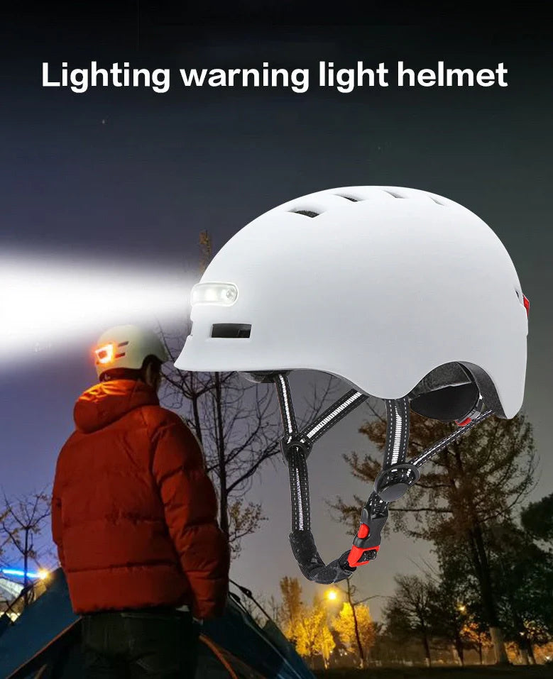 Black cycling helmet with built-in LED headlight and taillight showing adjustable dial and ventilation ports