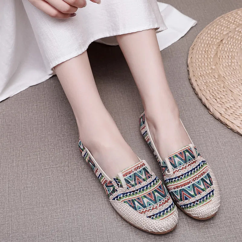 Women's flat heel ethnic cloth shoes in blue with colour stitching detail on a low-top, shallow mouth design.