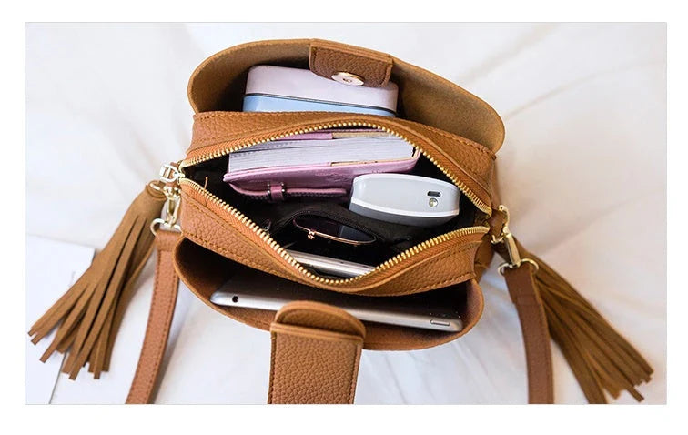 Stylish tassel bucket bag in various colors, featuring a spacious interior, adjustable strap, and premium materials for a Kiwi-inspired Korean look.