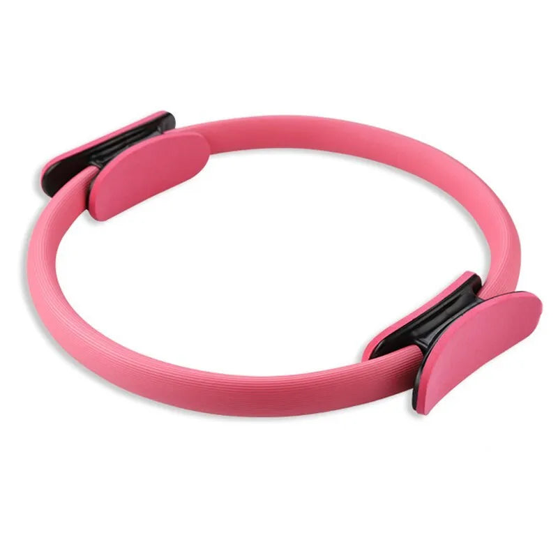 Pink Pilates ring with ergonomic curve on floor for core strength and posture exercises