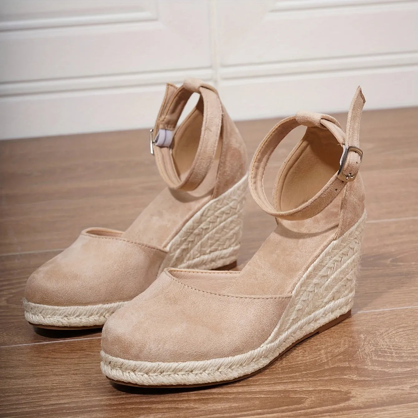 Women's apricot and black suede Roman-style wedge sandals with buckle and rubber sole.