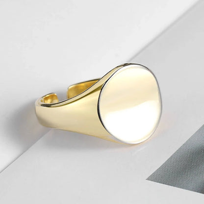 Adjustable oval smooth ring with polished electroplated finish in platinum and gold