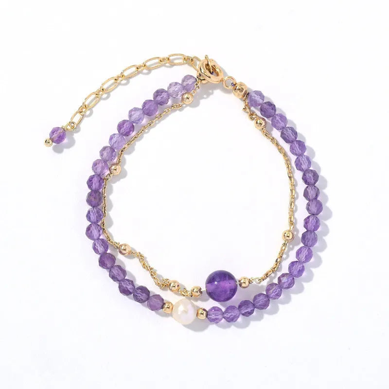 Close-up of a women's amethyst bracelet with diamond-cut crystal beads and Chinese style design.