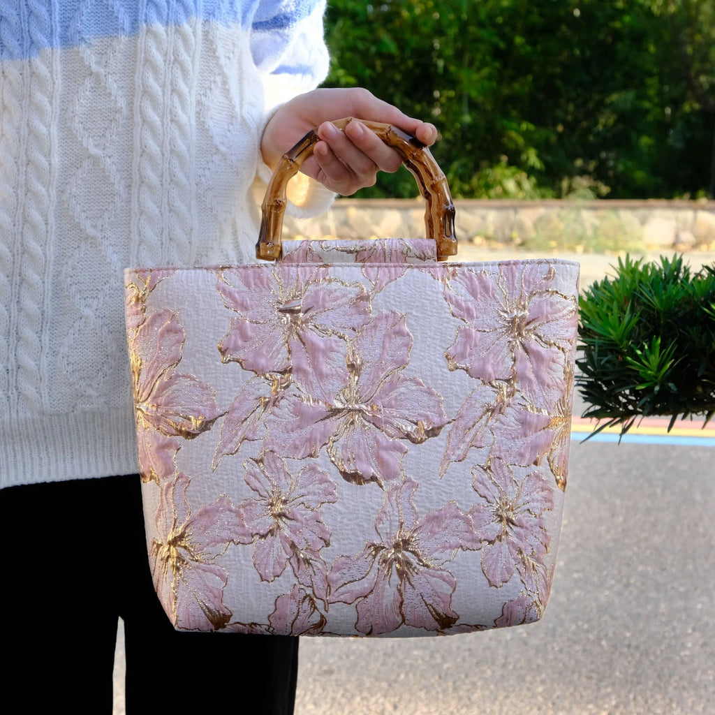 Light blue canvas bag with gold floral pattern showing double shoulder straps and square 30cm shape
