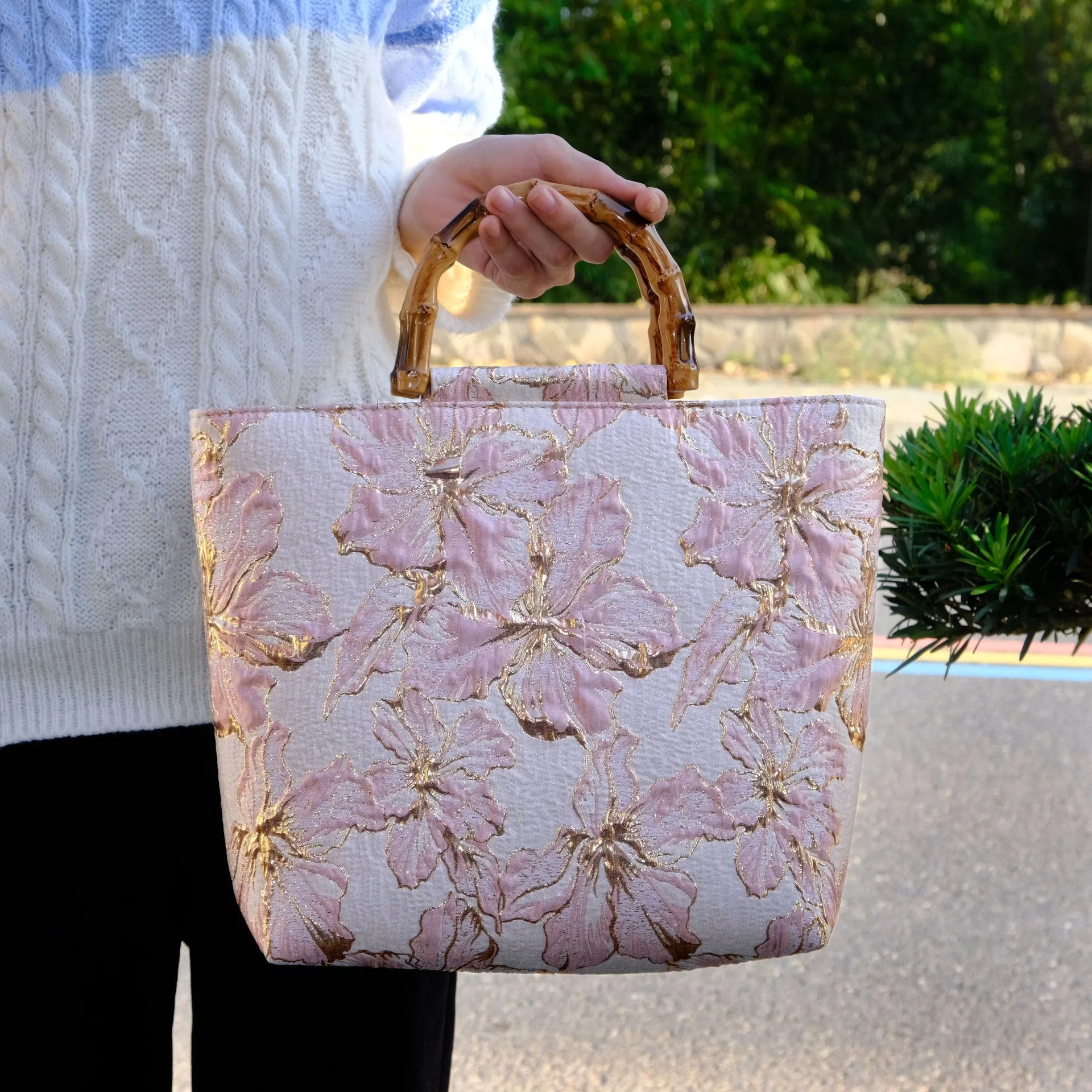 Light blue canvas bag with gold floral pattern showing double shoulder straps and square 30cm shape