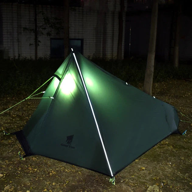 Green poleless camping tent with right opening showing interior 220cm length and 115cm height