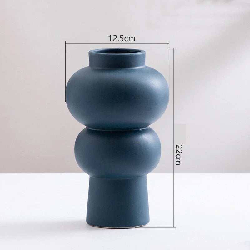 Nordic minimalist ceramic vase in blue, yellow, and orange with glazed finish