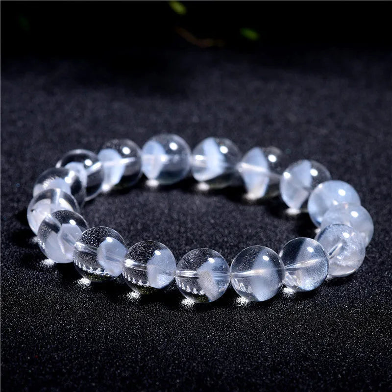 Women's adjustable white crystal bracelet with a pyramid bead and ruyi charm, shown on a wrist.