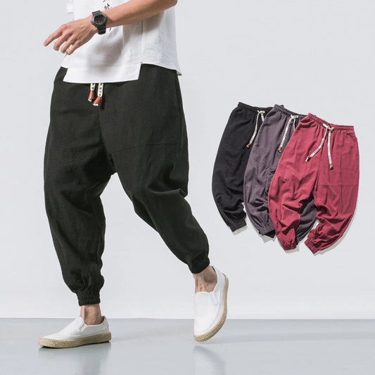 Premium men's streetwear joggers in black, navy, and gray colors with adjustable waistband and pockets