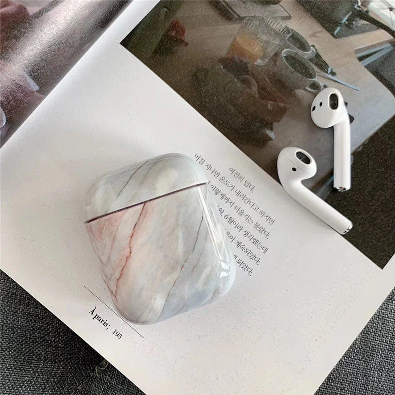 White marble AirPods protective case with hard PC construction that prevents scratches and absorbs impacts while maintaining wireless charging compatibility
