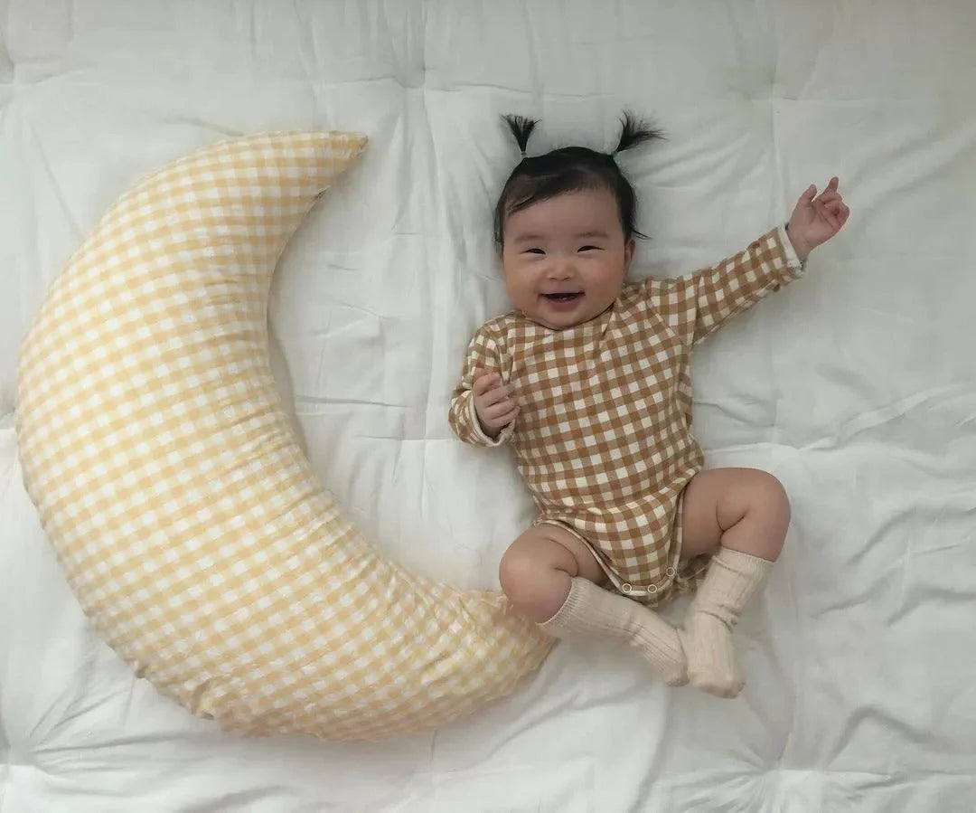 Moon-shaped baby nursing pillow in plaid cotton for newborns, available in yellow, green, and brown