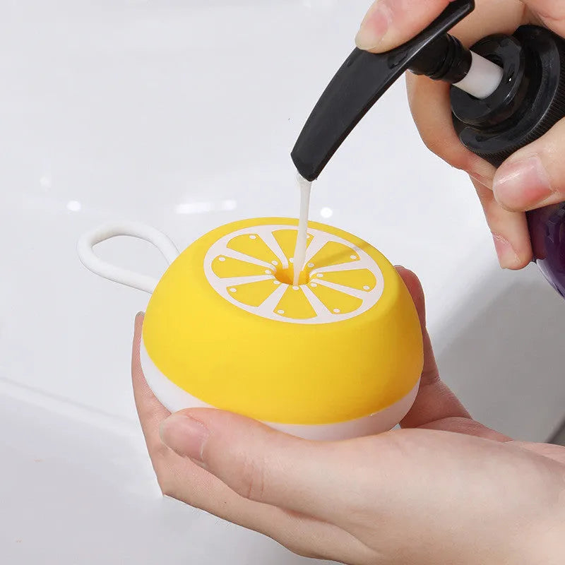 Yellow silicone pet bath brush and massage comb with 3D massage head on a blue background.
