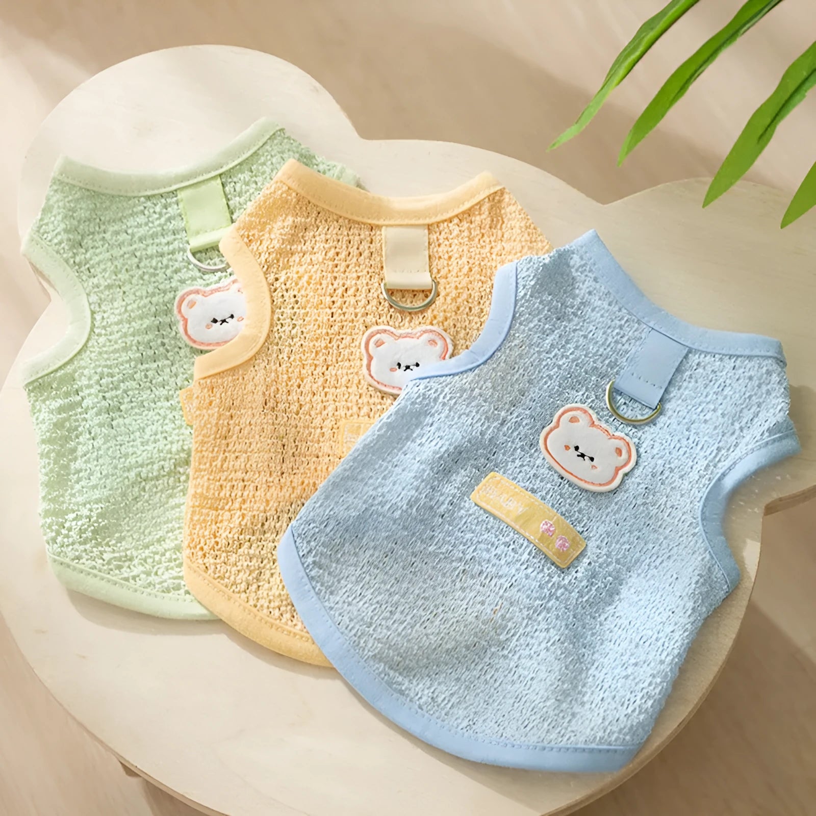 Green knitted cat clothing with a hollowed-out cartoon bear patch design