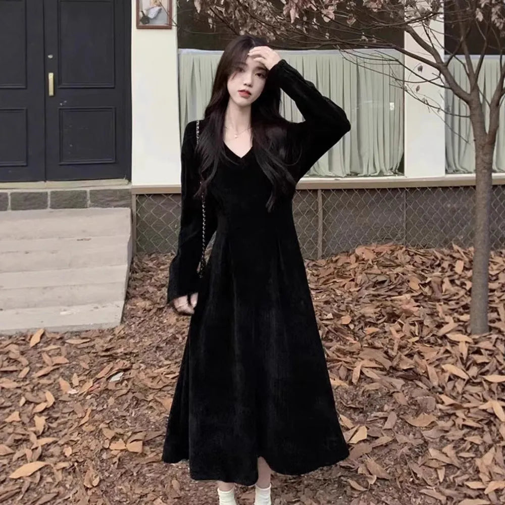 Women's milky white V-neck knitted long dress with princess sleeves on a hanger.