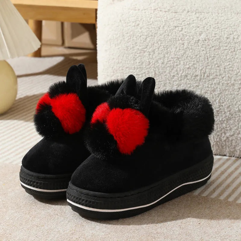 A pair of thick-soled grey plush oversleeve slippers with a textured non-slip sole.
