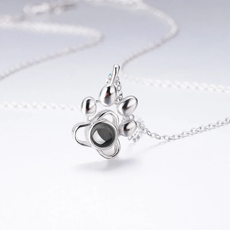 Personalized silver dog paw projection necklace with adjustable chain