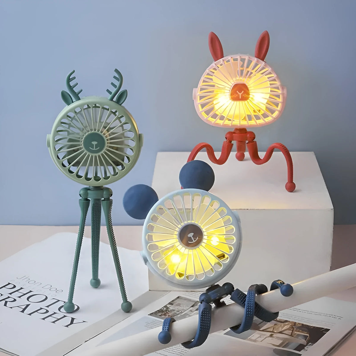 Cute animal design mini stroller fan with LED night light and flexible clip in pink on a stroller