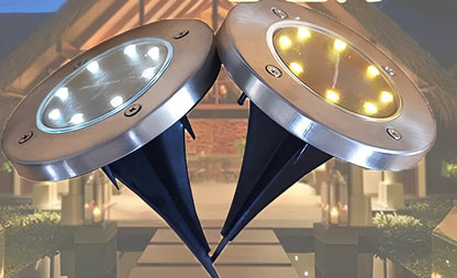 8LED waterproof solar garden light staked in lawn with warm glow, IP65 rated for rain resistance