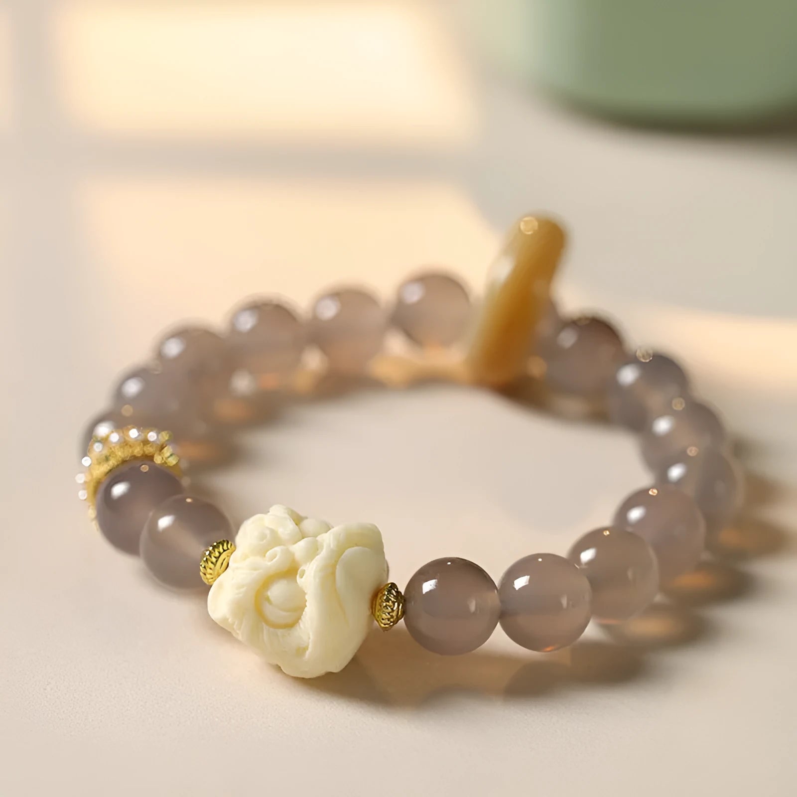 Grey agate melilite bracelet with 10mm round beads and hand-woven construction