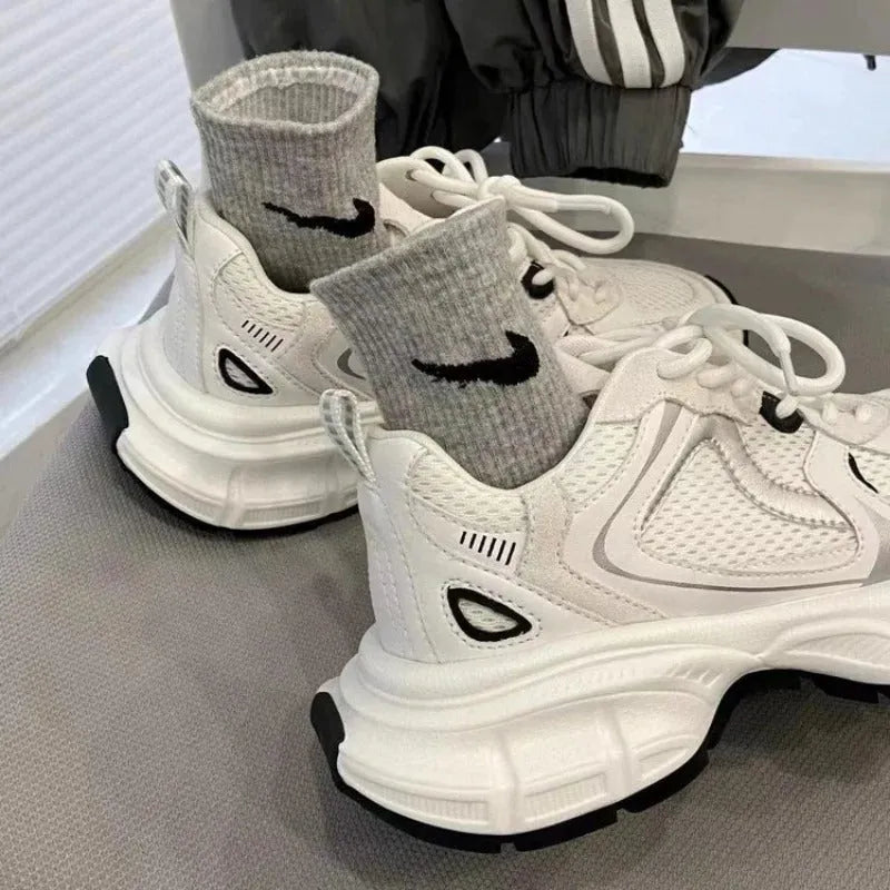 Beige mesh platform sports shoes with a wedge heel and front lace-up fastening on a rubber sole.