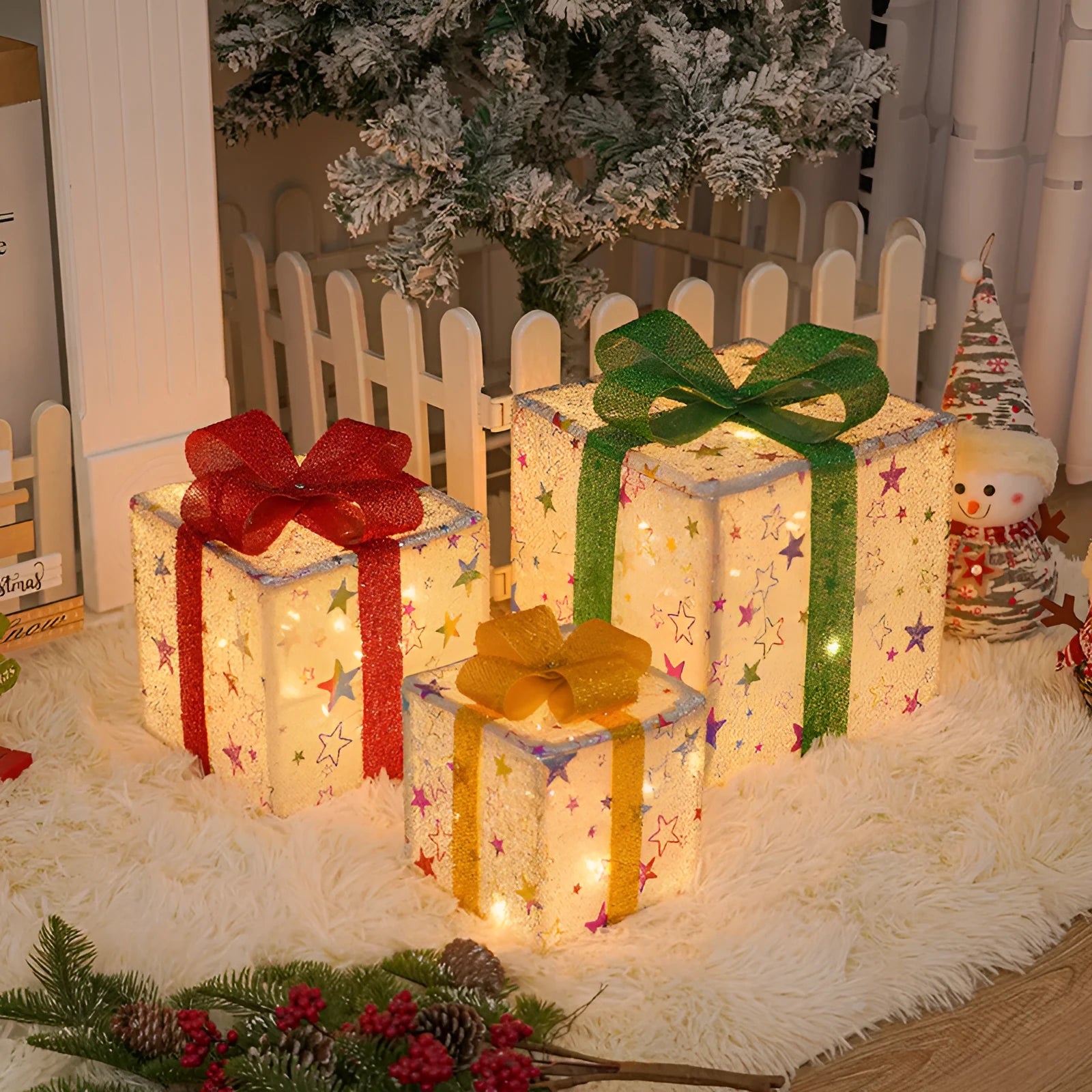 Set of three lighted Christmas gift box decorations with bows and LED lights for outdoor holiday decor