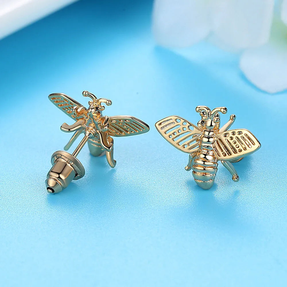Three styles of Korean inlaid crystal rhinestone bee and flower stud earrings on a white background