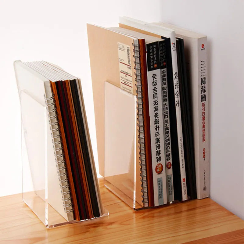 Transparent acrylic bookshelf holding a small stack of books on a wooden desk.