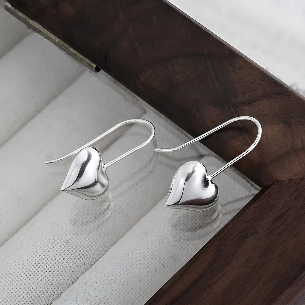 Korean-style silver heart earrings with three-dimensional design and glossy finish