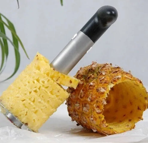 Stainless steel pineapple corer slicer with ABS handle showing cutting mechanism