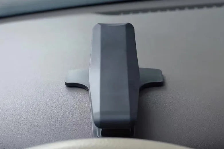 Black G-40 car bracket attached to steering wheel holding a mobile phone for navigation