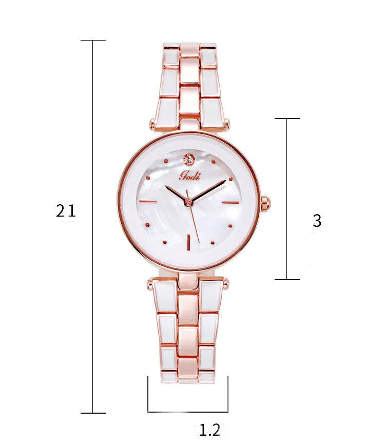 White dial ladies quartz watch with rose gold accents, steel strap, 30mm round alloy case on flat surface