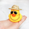 Yellow cartoon duck wearing a straw hat car decoration with adhesive glue and sunglasses accessory.